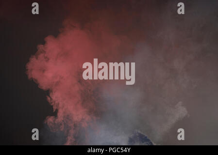 The explosion of multi colored powder. Beautiful rainbow color powder fly away. The cloud of glowing color powder on black background Stock Photo