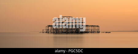 Long exposure panoramic image of the old West Pier in Brighton at sunset, Brighton, East Sussex, England
