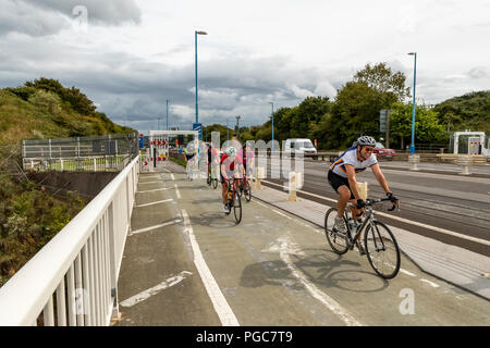 Cyclists using the other traffic lane to cross the M48 Severn Bridge from England into Wales. UK Stock Photo