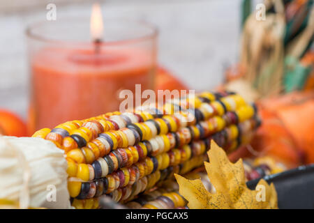 Selective focus on Indian corn in front of a candle Stock Photo