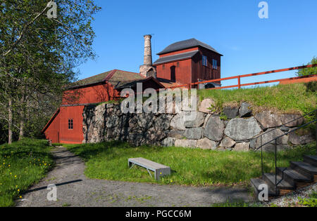 PERSHYTTAN, SWEDEN ON MAY 18, 2018. Outdoor view of the old smeltery, Iron foundry. Stone wall this side. Editorial Stock Photo