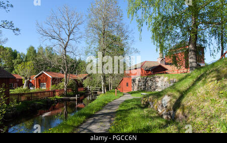 PERSHYTTAN, SWEDEN ON MAY 18, 2018. View of the old smeltery, Iron foundry. Stone wall, buildings, a pond this side. Editorial. Stock Photo
