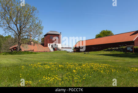 PERSHYTTAN, SWEDEN ON MAY 18, 2018. Outdoor view of the old smeltery, Iron foundry. Flowers and meadows this side. Editorial Stock Photo