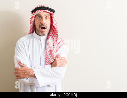 Senior arabic man scared in shock with a surprise face, afraid and excited with fear expression Stock Photo