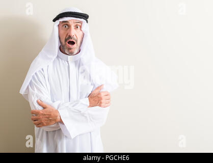 Senior arabic man scared in shock with a surprise face, afraid and excited with fear expression Stock Photo