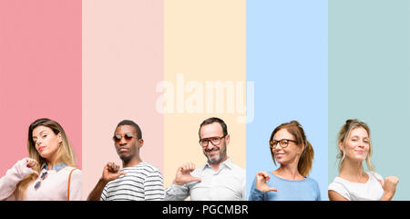 Mixed group of people, women and men proud, excited and arrogant, pointing with victory face Stock Photo