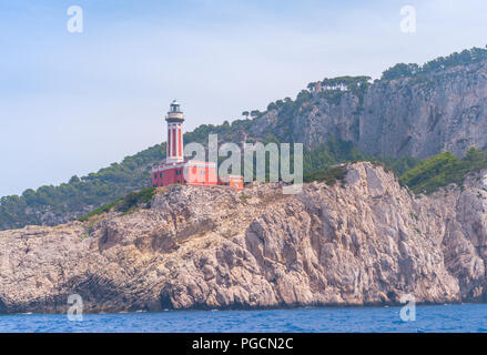 A view of Punta Carena Lighthouse, on the island of Capri in the background the rocks of Faraglioni can be seen