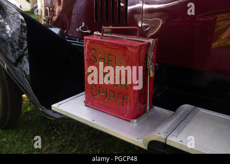 An external petrol can strapped onto the running board of a vintage car. Stock Photo