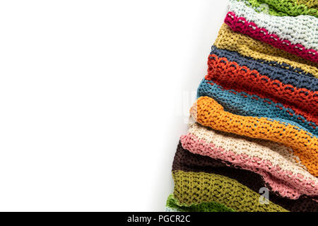 Wool blanket, colorful, knitted large chunky yarn. Close-up of knitted blanket on white background. Stock Photo