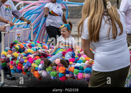 Cardiff, Wales, August 25, 2018:Child rides on a mobile bed along NHS staff at the  Annual Pride Cymru Parade  in Cardiff, Wales on August 25, 2018 ©Daniel Damaschin Credit: Daniel Damaschin/Alamy Live News Stock Photo