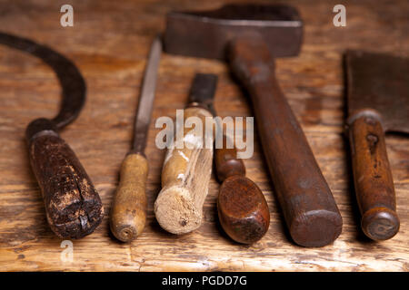 Antique rusty tools on an old wooden desk Stock Photo