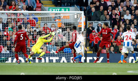 Liverpool's Ramses Alisson (second left) saves a shot on goal from Brighton & Hove Albion's Pascal Gross (centre right) during the Premier League match at Anfield, Liverpool. Stock Photo