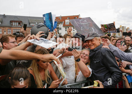 Worms, Germany. 24th Aug, 2018. Terence Hill poses for a picture with his fans. Italian actor Terence Hill visited the German city of Worms, to present his new movie (My Name is somebody). Terence Hill added the stop in Worms to his movie promotion tour in Germany, to visit a pedestrian bridge, that is unofficially named Terence-Hill-Bridge (officially Karl-Kubel-Bridge). Credit: Michael Debets/Pacific Press/Alamy Live News Stock Photo