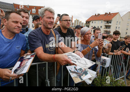 Worms, Germany. 24th Aug, 2018. Fans shout towards Terence Hill and wave things for him to sign. Italian actor Terence Hill visited the German city of Worms, to present his new movie (My Name is somebody). Terence Hill added the stop in Worms to his movie promotion tour in Germany, to visit a pedestrian bridge, that is unofficially named Terence-Hill-Bridge (officially Karl-Kubel-Bridge). Credit: Michael Debets/Pacific Press/Alamy Live News Stock Photo