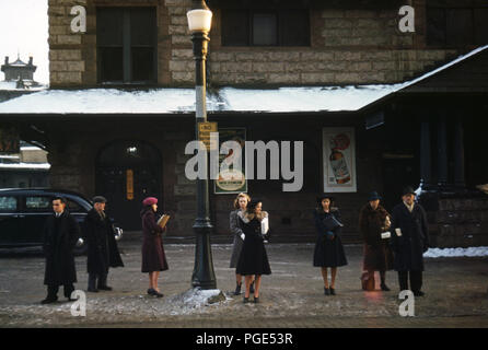 Title: Commuters, who have just come off the train, waiting for the bus to go home, Lowell, Mass. Stock Photo