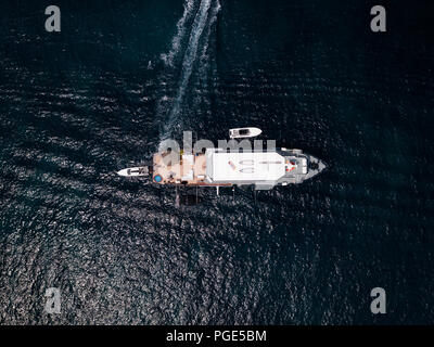 Aerial view of a luxury yacht at anchor on deep blue sea in  Sardinia, Italy. Stock Photo