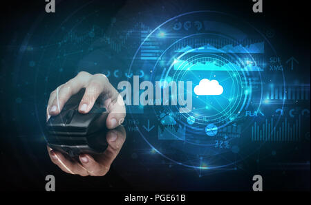 Hand using wireless mouse with cloud technology concept and dark background Stock Photo