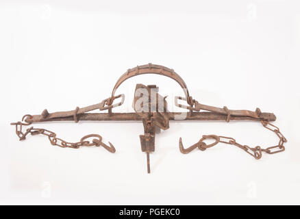 A very large, toothed  metal spring trap with anchor chains. Research would indicate it is from the middle of the 19th century and there is a suggesti Stock Photo