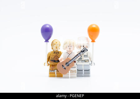 Lego luke skywalker holding guitar with rebel army and c3p0 holding balloon. Stock Photo