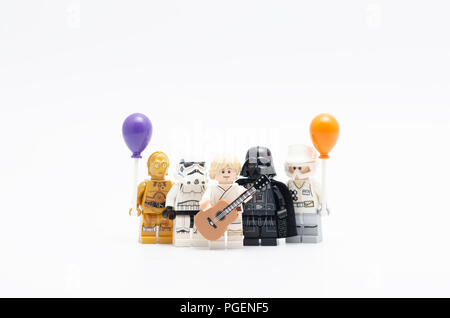 Lego luke skywalker holding guitar with darth vader, storm trooper and c3p0 holding balloon. Stock Photo