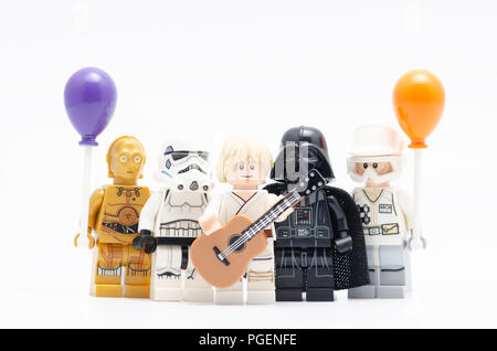 Lego luke skywalker holding guitar with darth vader, storm trooper and c3p0 holding balloon. Stock Photo