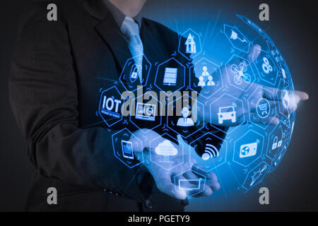 Internet of Things (IOT) technology with AR (Augmented Reality) on VR dashboard.business man with an open hand as showing something concept Stock Photo