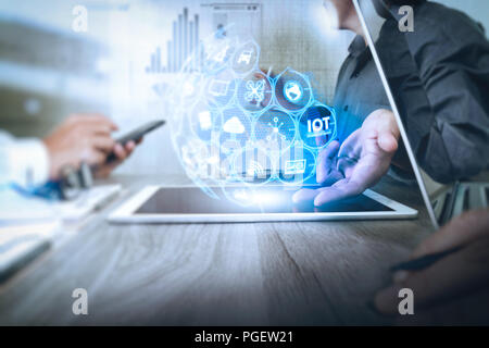 Internet of Things (IOT) technology with AR (Augmented Reality) on VR dashboard.Businessman making presentation with his colleagues and business strat Stock Photo