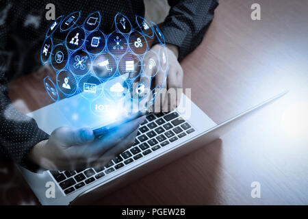 Internet of Things (IOT) technology with AR (Augmented Reality) on VR dashboard.business man hand using smart phone,laptop, online banking payment com Stock Photo