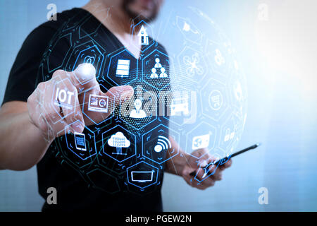 Internet of Things (IOT) technology with AR (Augmented Reality) on VR dashboard.Designer hand pressing an imaginary button,holding smart phone,digital Stock Photo