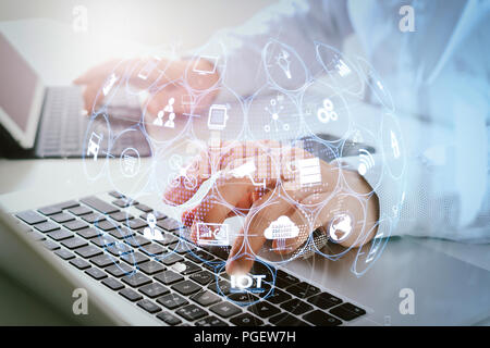 Internet of Things (IOT) technology with AR (Augmented Reality) on VR dashboard.businessman typing digital tablet with keyboard and laptop computer on Stock Photo