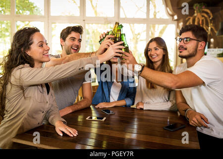 Group of friends hanging out and making a toast with beer Stock Photo