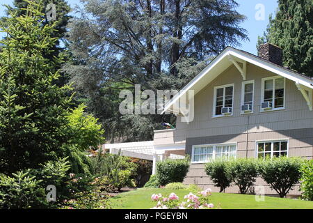 Peacock sits on the roof of a home at Chateau Ste. Michelle, Washington State's oldest winery, located in Woodinville, Washington, near Seattle. Stock Photo