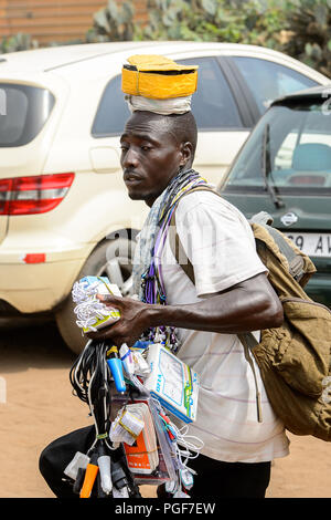 LOME, TOGO - Jan 9, 2017: Unidentified Togolese man carries accessories for the cellphone at the Lome port. Togo people suffer of poverty due to the b Stock Photo