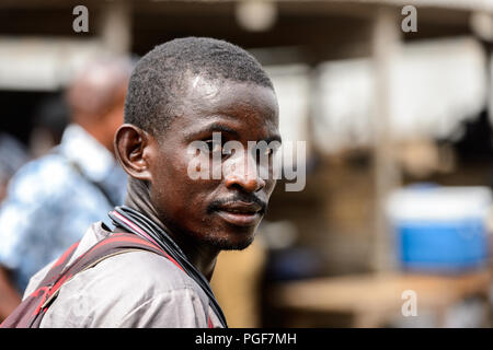 LOME, TOGO - Jan 9, 2017: Unidentified Togolese man with mustache at the Lome port. Togo people suffer of poverty due to the bad economy Stock Photo