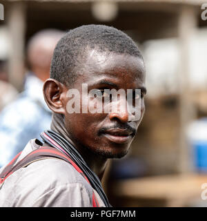 LOME, TOGO - Jan 9, 2017: Unidentified Togolese man with mustache at the Lome port. Togo people suffer of poverty due to the bad economy Stock Photo