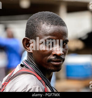 LOME, TOGO - Jan 9, 2017: Unidentified Togolese man with mustache at the Lome port. Togo people suffer of poverty due to the bad economy Stock Photo