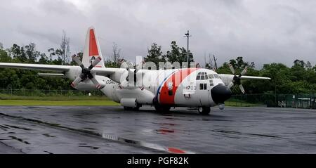 An Air Station Barbers Point HC-130 aircraft awaits tasking at Hilo International Airport, Hawaii, in response to Hurricane Lane, Aug. 24, 2018. Coast Guard units across the Hawaiian Islands were standing by to respond to distress calls caused by the hurricane. (U.S. Coast Guard photo by Chief Petty Officer Billy Mapakoi/Released) Stock Photo