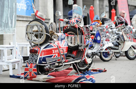 Brighton, UK. 26 August 2018.  Despite the bad weather Mods with their scooters descend on Brighton seafront today as part of their Mod Weekender event . Every August Bank Holiday hundreds of Mods from around the country descend on Brighton for their traditional event which depending on the weather includes a ride out to Beach Head inspired by the film Quadrophenia Photograph taken by Simon Dack Credit: Simon Dack/Alamy Live News Credit: Simon Dack/Alamy Live News Stock Photo