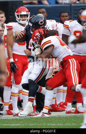 Illinois, USA. 25 August 2018. Chiefs #27 Kareem Hunt is tackled by Bears  #44 Nick Kwiatkoski and #95 Roy Robertson-Harris during the NFL Game  between the Kansas City Chiefs and Chicago Bears