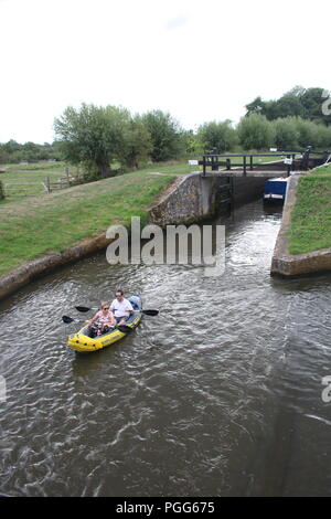 Paddling down river in inflatable canoe Stock Photo 