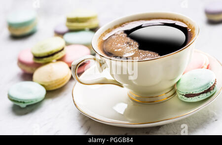 Cup of black coffee with french  macaroons. Stock Photo