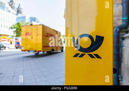 MAGDEBURG / GERMANY - AUGUST 22, 2018: German parcel van from DHL stands in a pedestrian area to load packages. Stock Photo