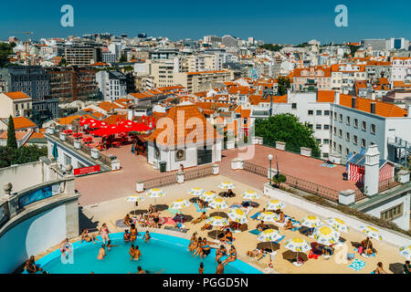 LISBON, PORTUGAL - AUGUST 20, 2017: People Having Fun In Pool On Top Of Lisbon City Skyline Buildings Stock Photo