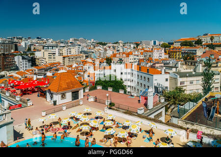 LISBON, PORTUGAL - AUGUST 20, 2017: People Having Fun In Pool On Top Of Lisbon City Skyline Buildings Stock Photo