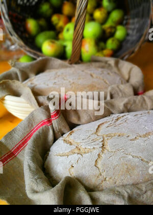 Bread dough is waiting for bake in a wooden baking basket. Stock Photo
