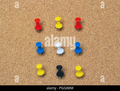 Clse-up, nine colored pinned button on a cork board Stock Photo