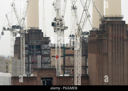 Exterior facade detail with cranes. Battersea Power Station, under construction, London, United Kingdom. Architect: Sir Giles Gilbert Scott, 1953. Stock Photo
