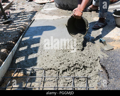 worker pour concrete into wire mesh steel rod Stock Photo