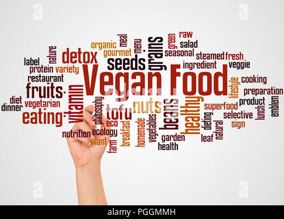 Vegan food word cloud and hand with marker concept on gradient background. Stock Photo