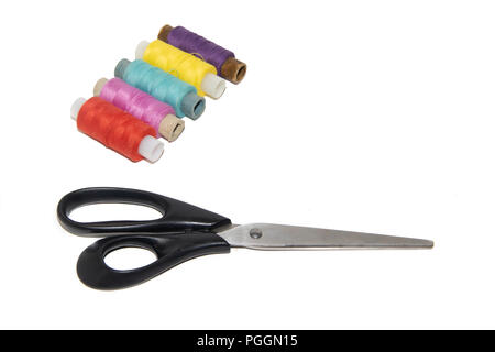 colored thread and scissors on a white background. items for embroidery. handmade Stock Photo